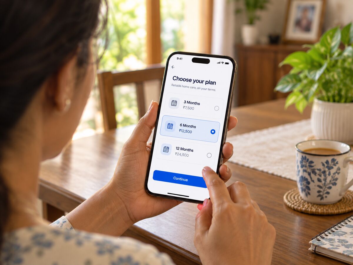 Choosing a 3, 6 or 12 month plan on a phone at a Kerala dining table