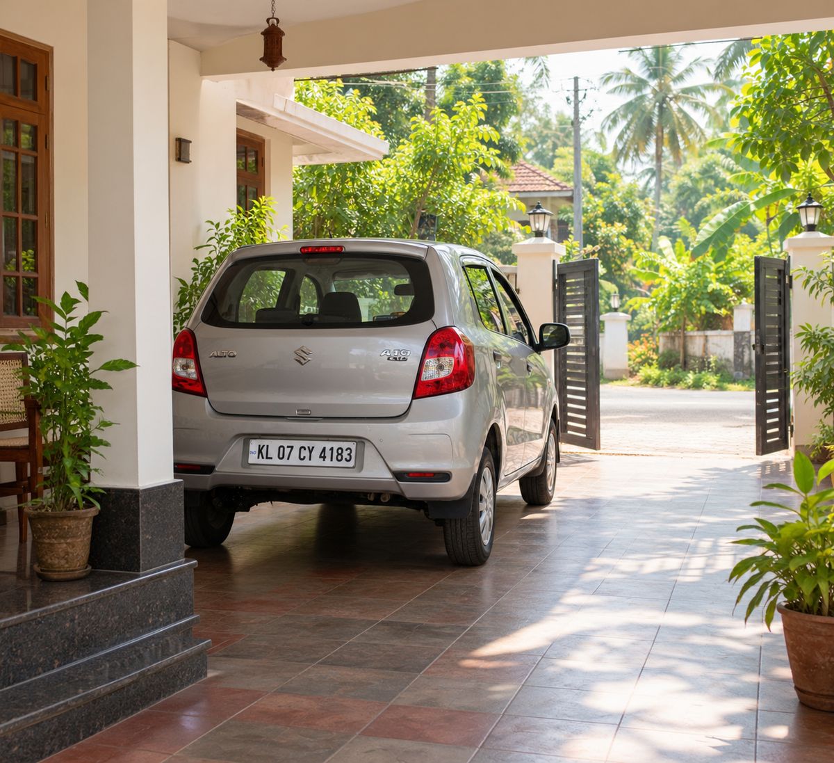 A family car parked in the driveway of a Kerala home